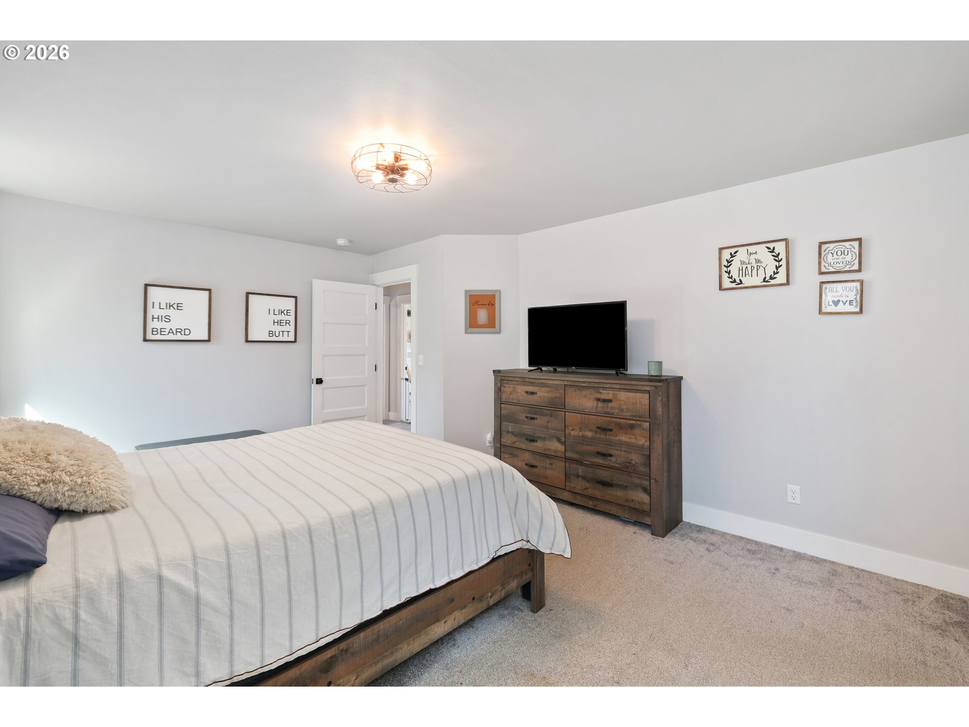 204 St Helens Way Winlock, WA 98596 - Photo 12 of 42 a bedroom with a bed and a flat screen tv