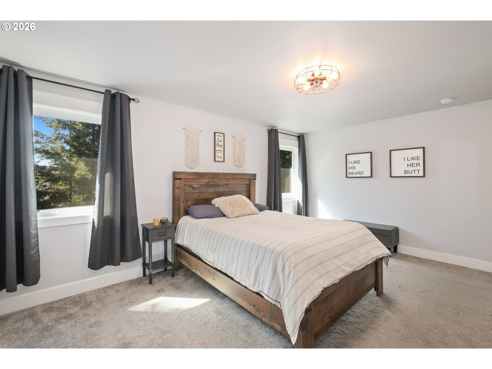 204 St Helens Way Winlock, WA 98596 - Photo 13 of 42 a bedroom with a large bed and a chandelier