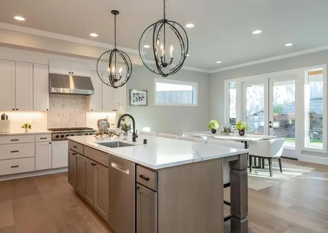 a very nice looking open kitchen with a large window