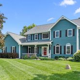a front view of a house with a yard