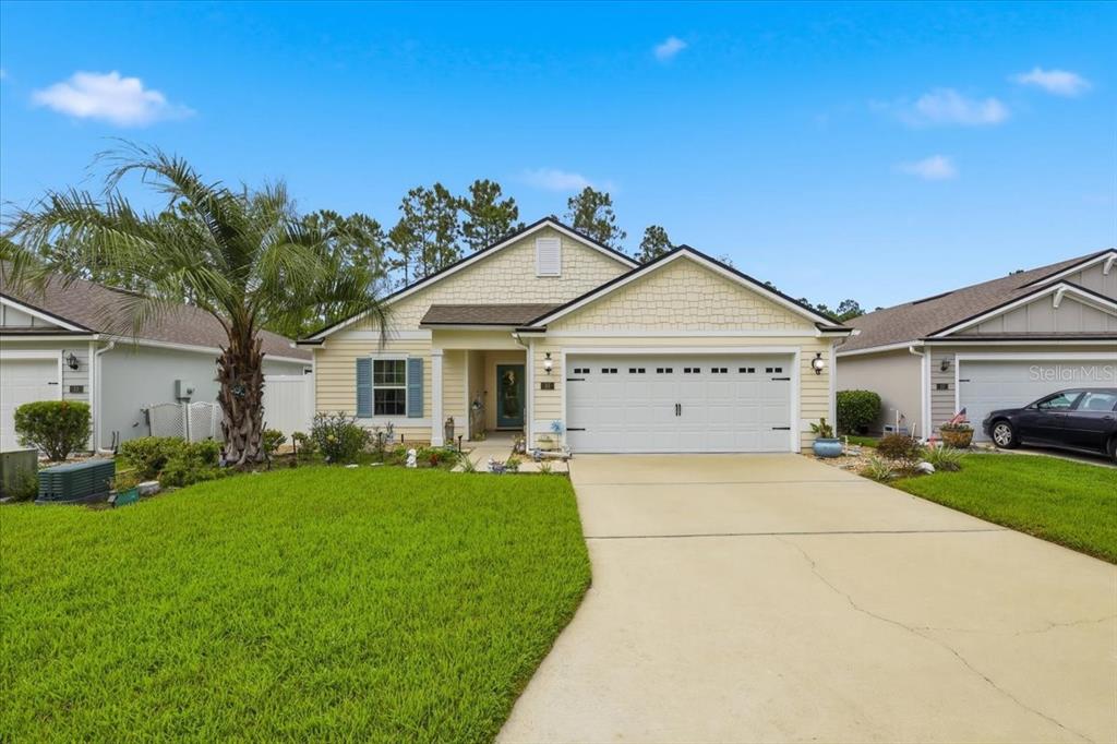 35 Birdie Way Bunnell, FL 32110 - Photo 1 of 57 a view of a house with a big yard and potted plants