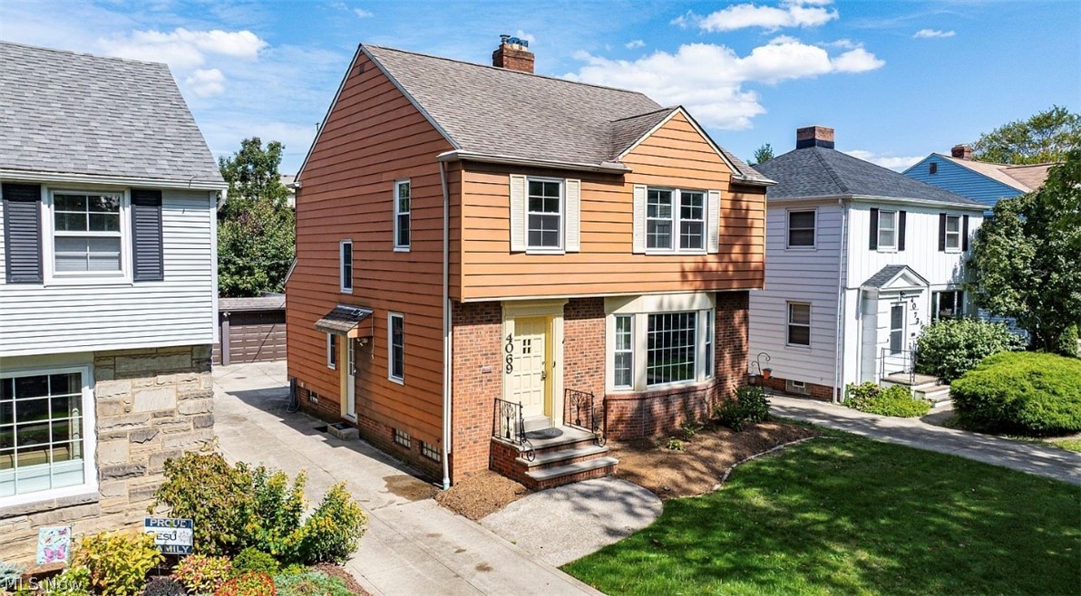 4069 Bushnell Road Cleveland, OH 44121 - Photo 2 of 39 View of front of house with brick siding and a chimney