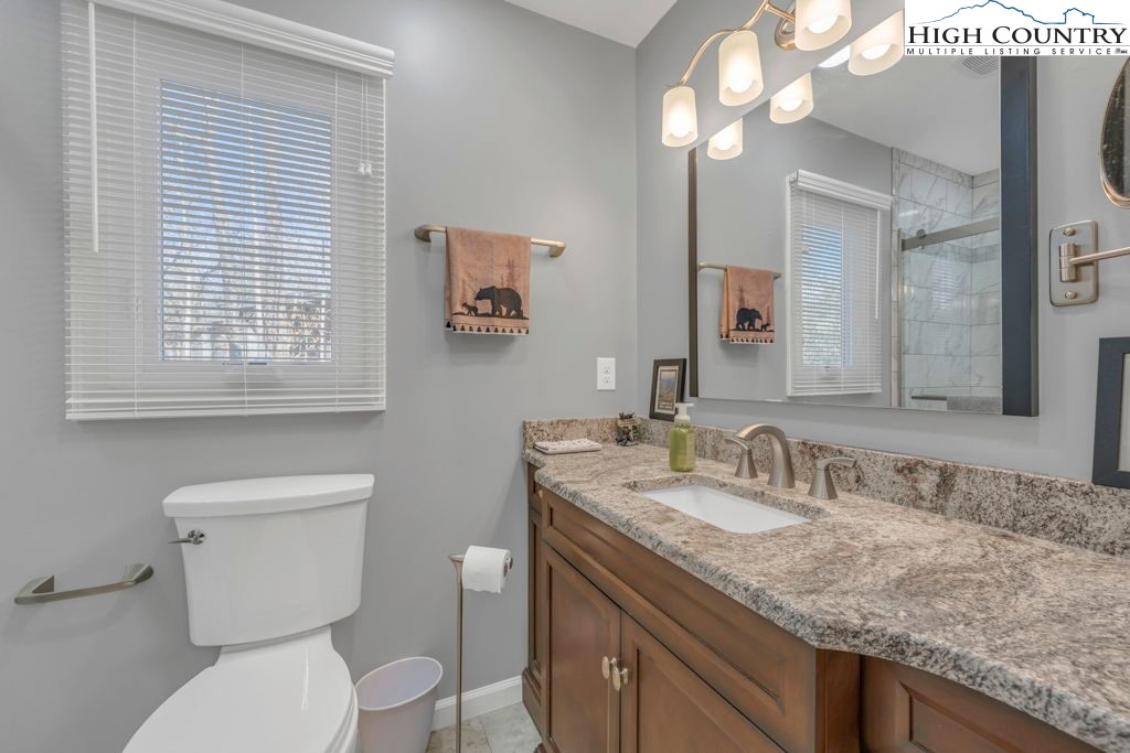 6 Ridgewood Lane Newland, NC 28657 - Photo 17 of 45 a bathroom with a granite countertop toilet sink and mirror