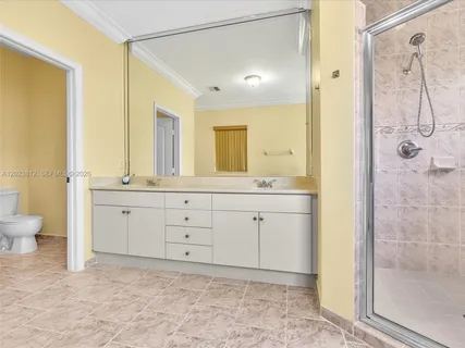 a spacious bathroom with a granite countertop sink mirror and a