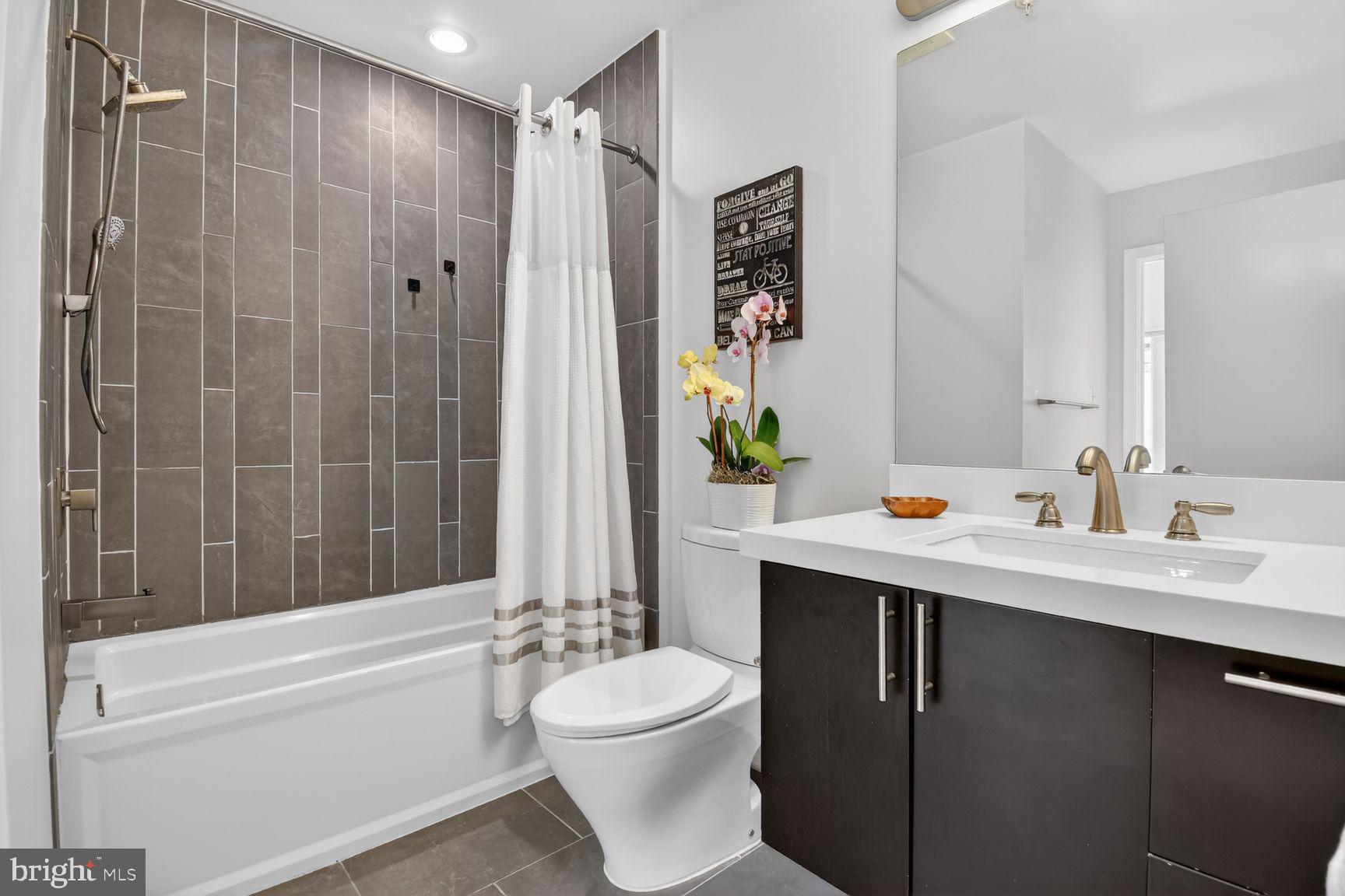 1443 Chapin Street Northwest, Unit 403 Washington, DC 20009 - Photo 14 of 24 a bathroom with a sink a toilet and shower