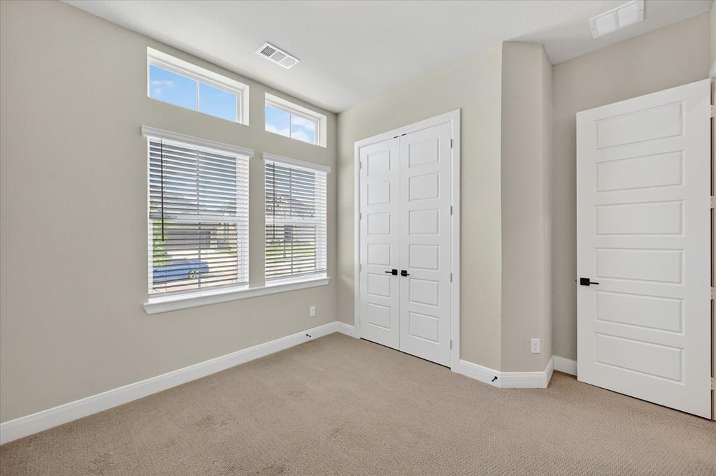 2237 Pika Road Northlake, TX 76247 - Photo 24 of 37 Carpeted room featuring multiple windows with blinds, transom windows, neutral wall tones, and white trim