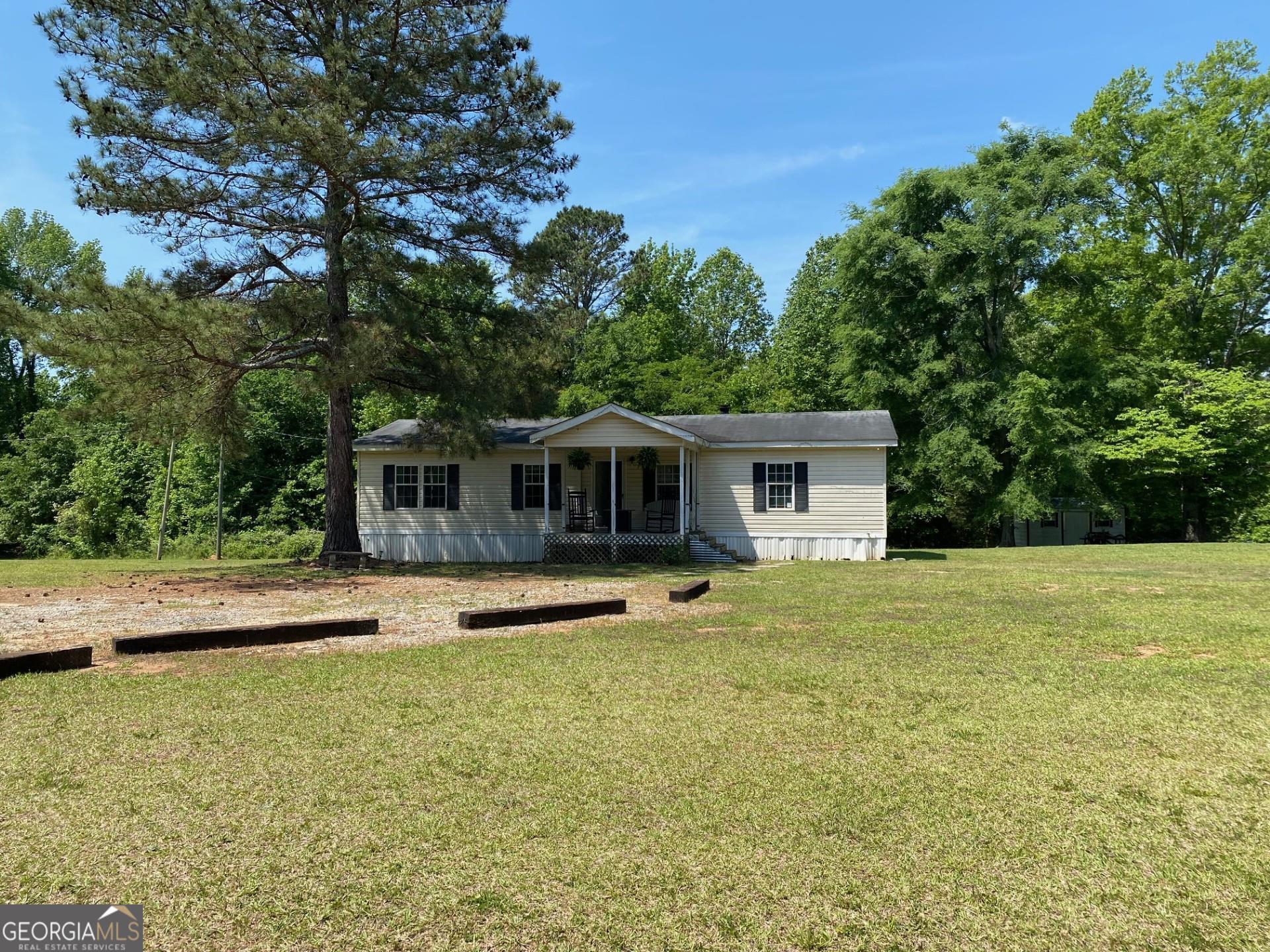 3031 Stoney Ridge Road Washington, GA 30673 - Photo 1 of 1 a front view of a house with a yard