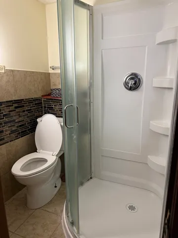 a bathroom with a toilet and a shower