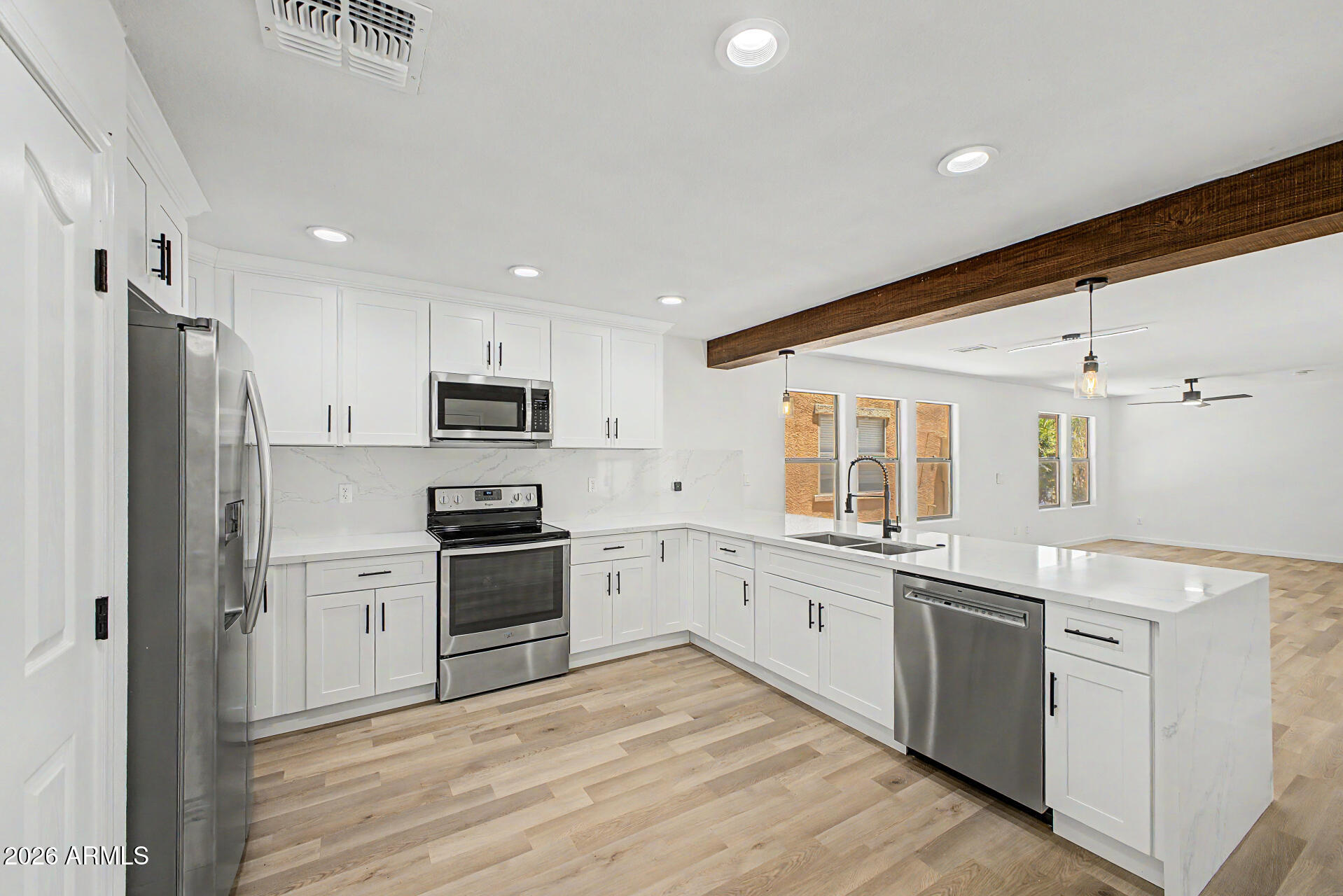 6452 West Ruth Avenue Glendale, AZ 85302 - Photo 12 of 35 a kitchen with stainless steel appliances granite countertop a refrigerator and a stove top oven