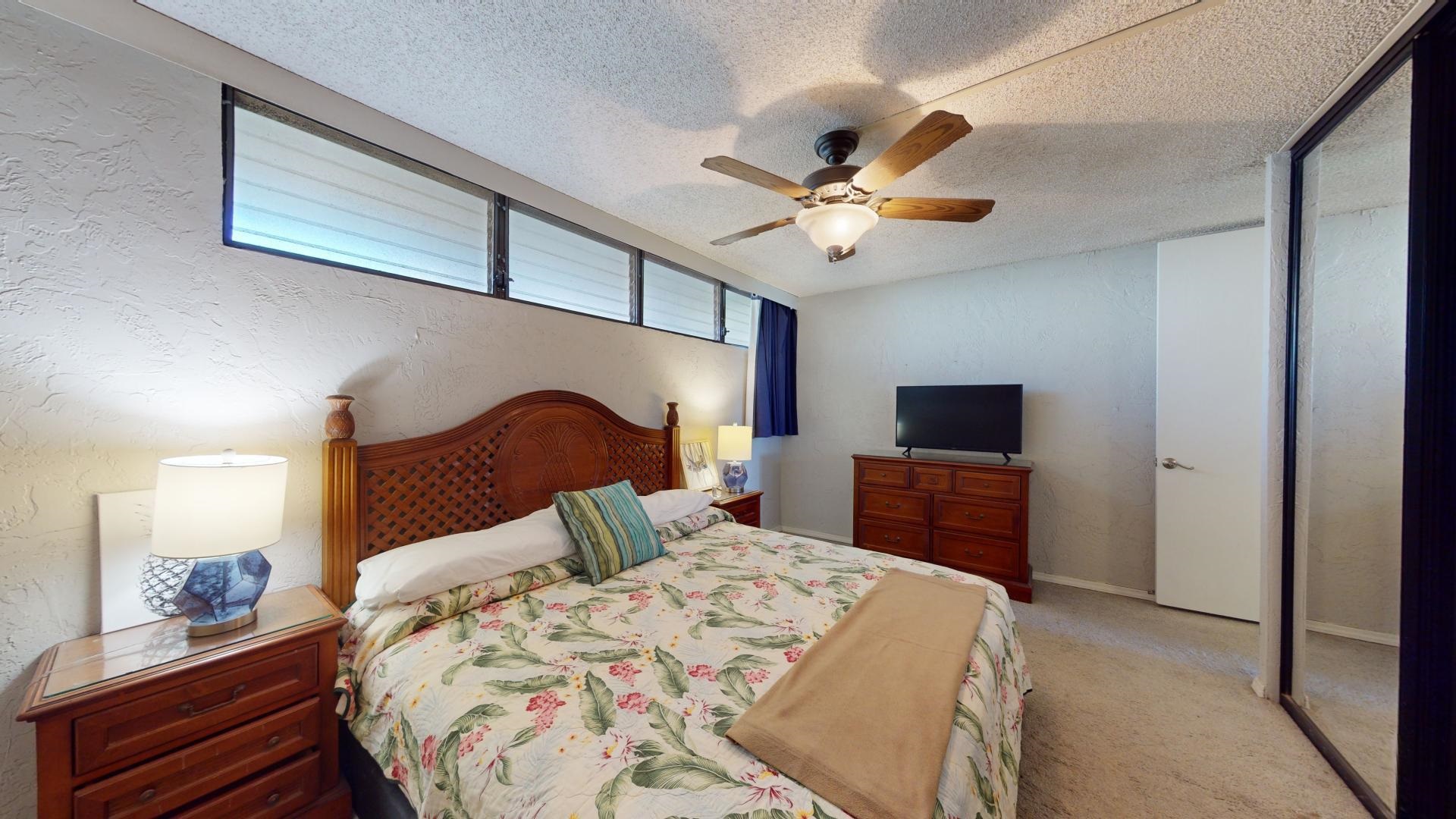 3543 Lower Honoapiilani Road, Unit A107 Lahaina, HI 96761 - Photo 12 of 19 a bedroom with a large bed and a tv