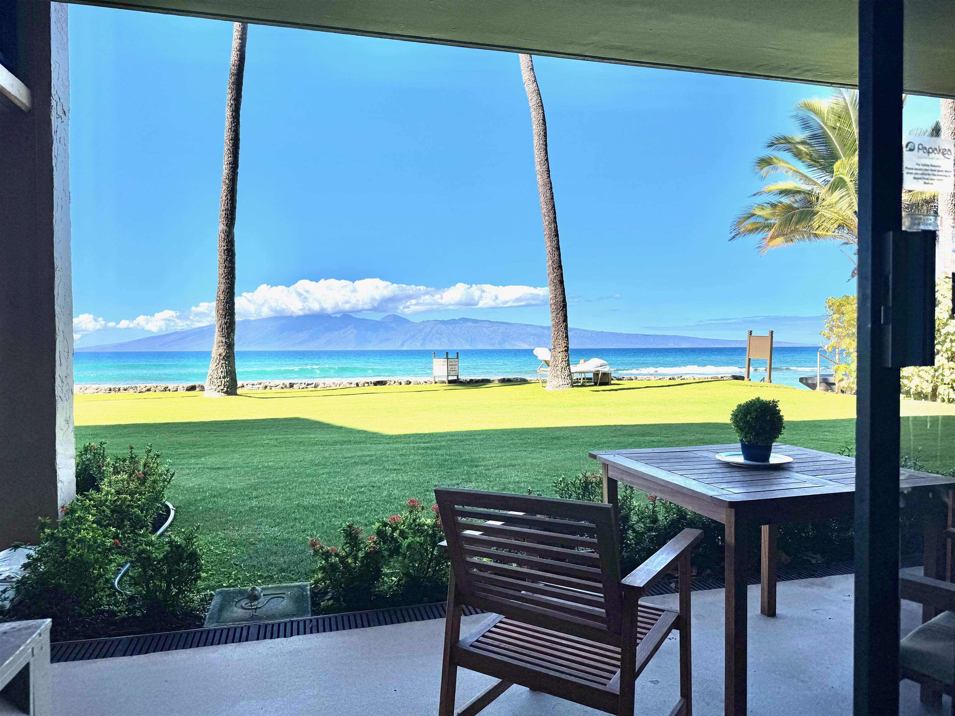 3543 Lower Honoapiilani Road, Unit A107 Lahaina, HI 96761 - Photo 19 of 19 a view of a outdoor space with a table and chairs