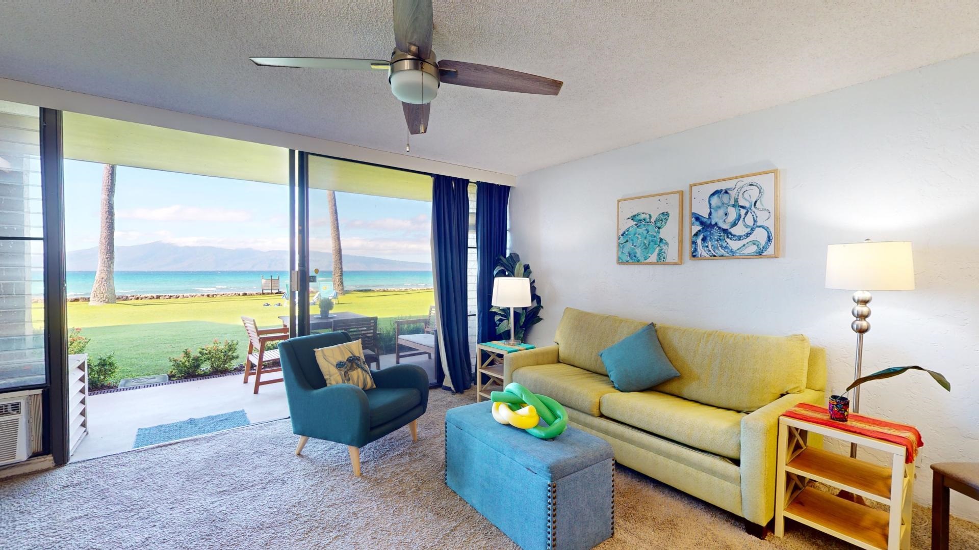 3543 Lower Honoapiilani Road, Unit A107 Lahaina, HI 96761 - Photo 6 of 19 a living room with furniture and a floor to ceiling window