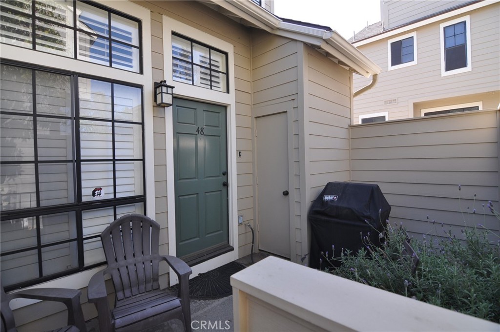 249 Alpine Street, Unit 48 Pasadena, CA 91106 - Photo 2 of 14 a view of a patio with table and chairs and wooden fence