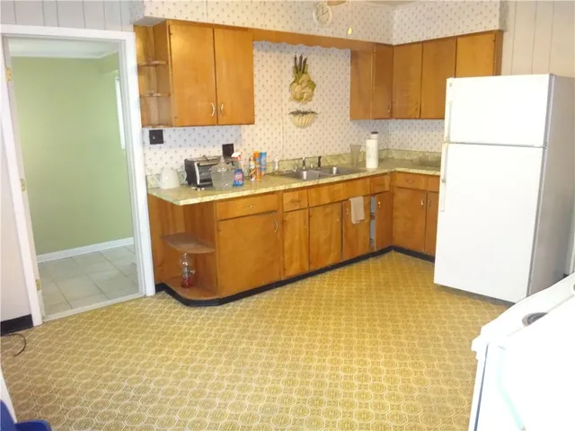 a kitchen with a sink appliances and cabinets