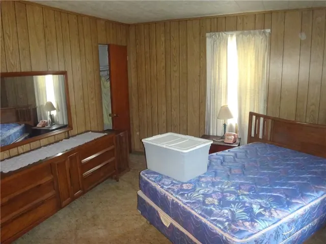 a spacious bathroom with a granite countertop sink and a bathtub