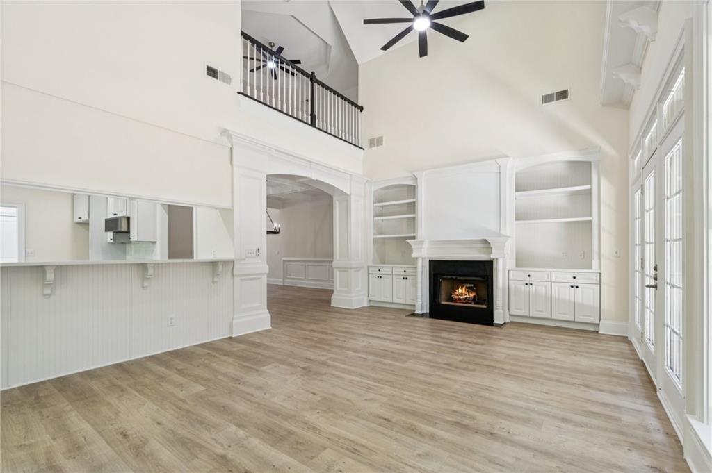 1950 Buford Dam Road, Unit 801 Cumming, GA 30041 - Photo 14 of 26 a view of a livingroom with a fireplace a ceiling fan and windows