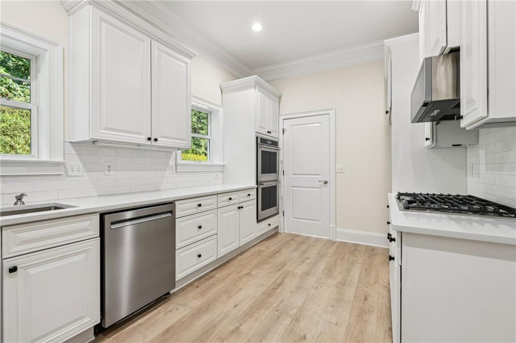 1950 Buford Dam Road, Unit 801 Cumming, GA 30041 - Photo 15 of 26 a kitchen with white cabinets and appliances