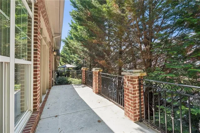 a view of balcony with wooden floor and fence