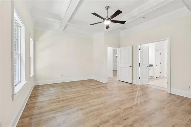 an empty room with fan and a ceiling fan