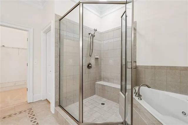 a bathroom with a shower and a bath tub