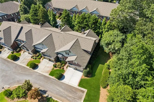 an aerial view of a house with swimming pool and garden