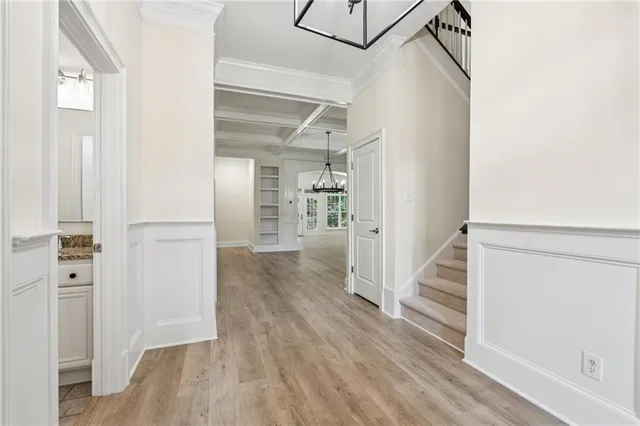 a view of a hallway with wooden floor and entryway