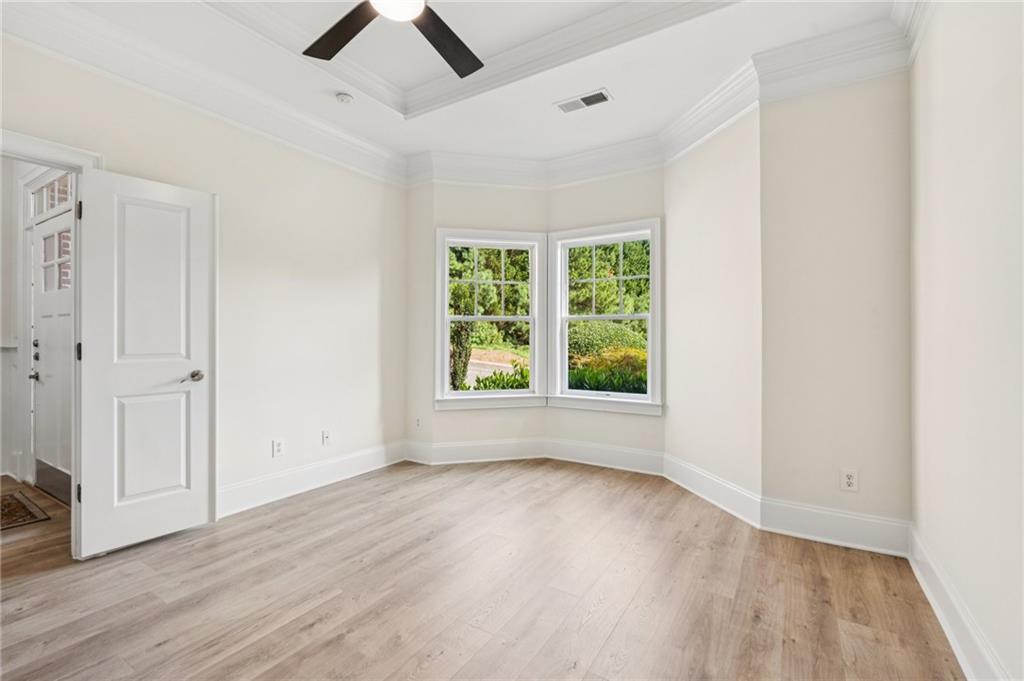 1950 Buford Dam Road, Unit 801 Cumming, GA 30041 - Photo 10 of 26 wooden floor in an empty room with a window