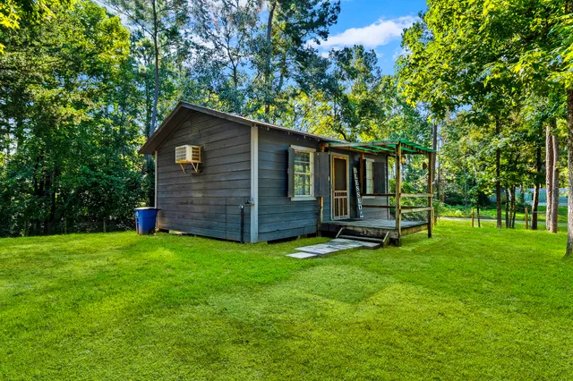 a view of a backyard with table and chairs and a tree