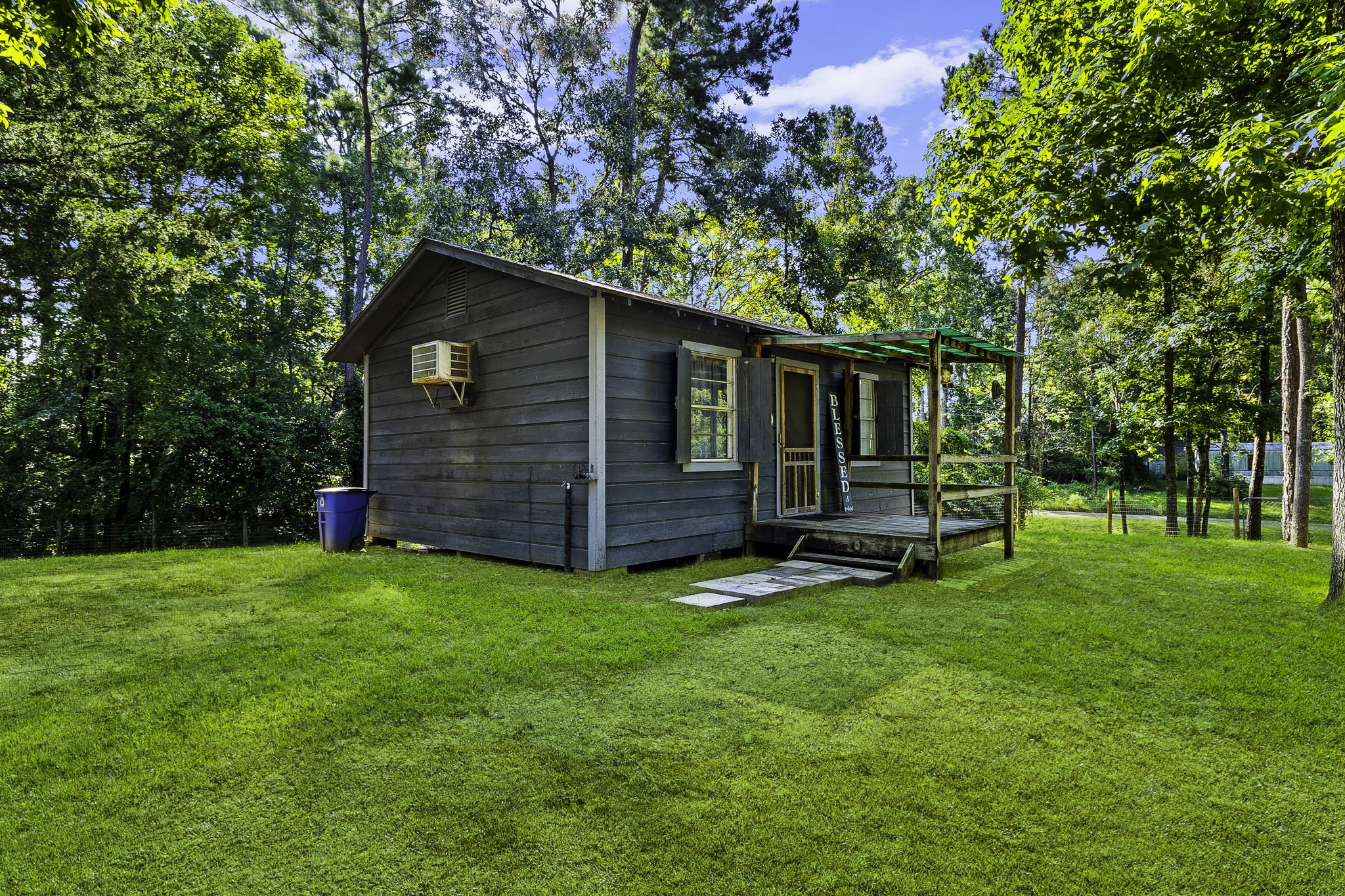 a view of a backyard with table and chairs and a tree