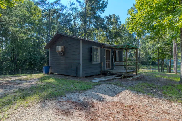 a view of backyard with wooden fence and a large tree