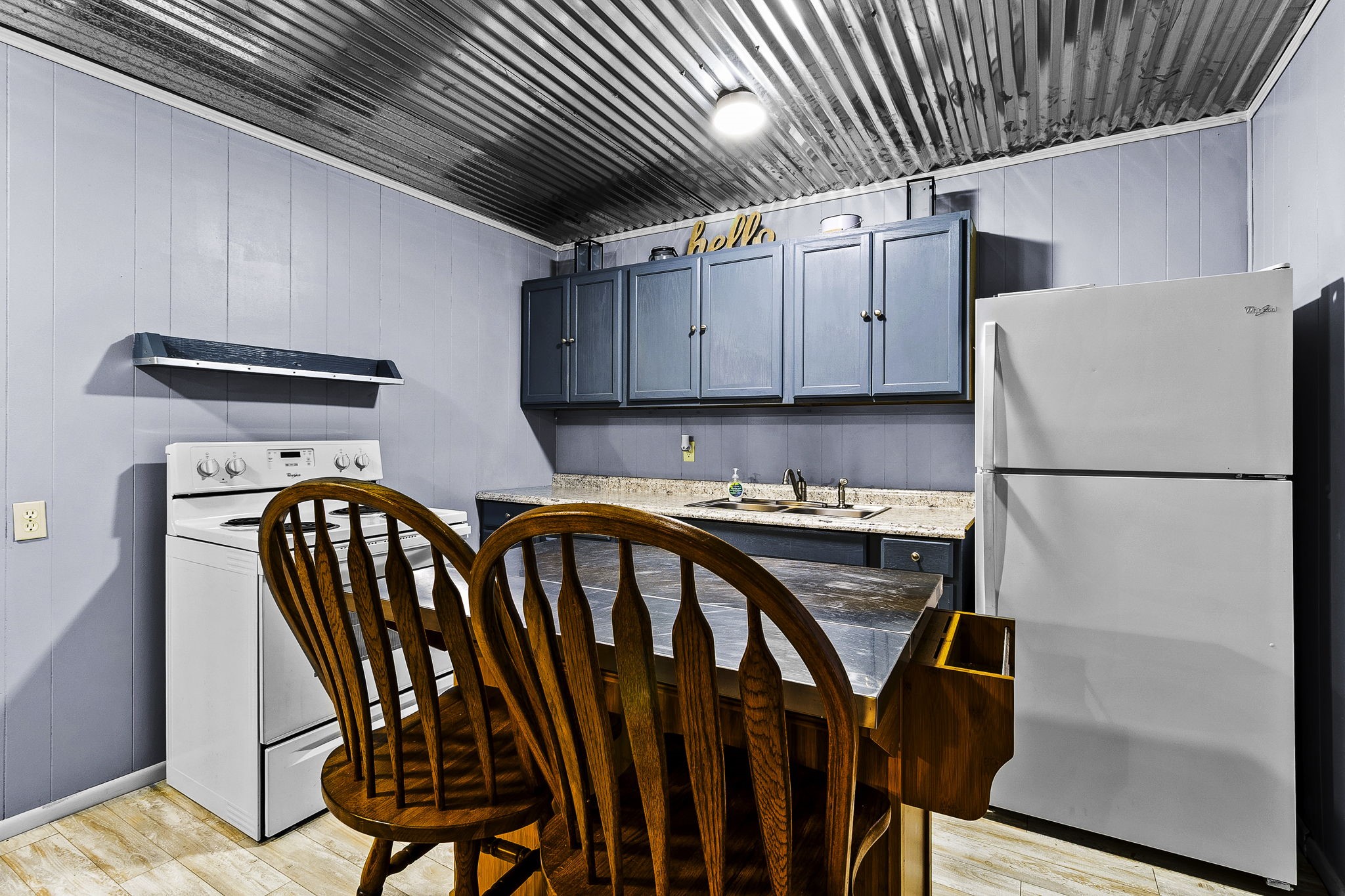 126 Pine Ridge Onalaska, TX 77360 - Photo 8 of 16 a kitchen with a sink a refrigerator and wooden floor