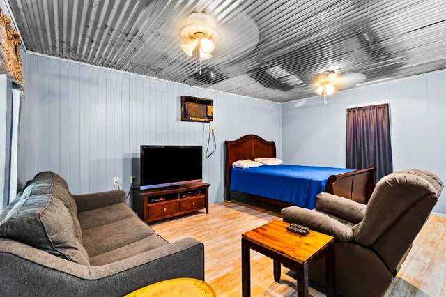 a living room with furniture and a flat screen tv