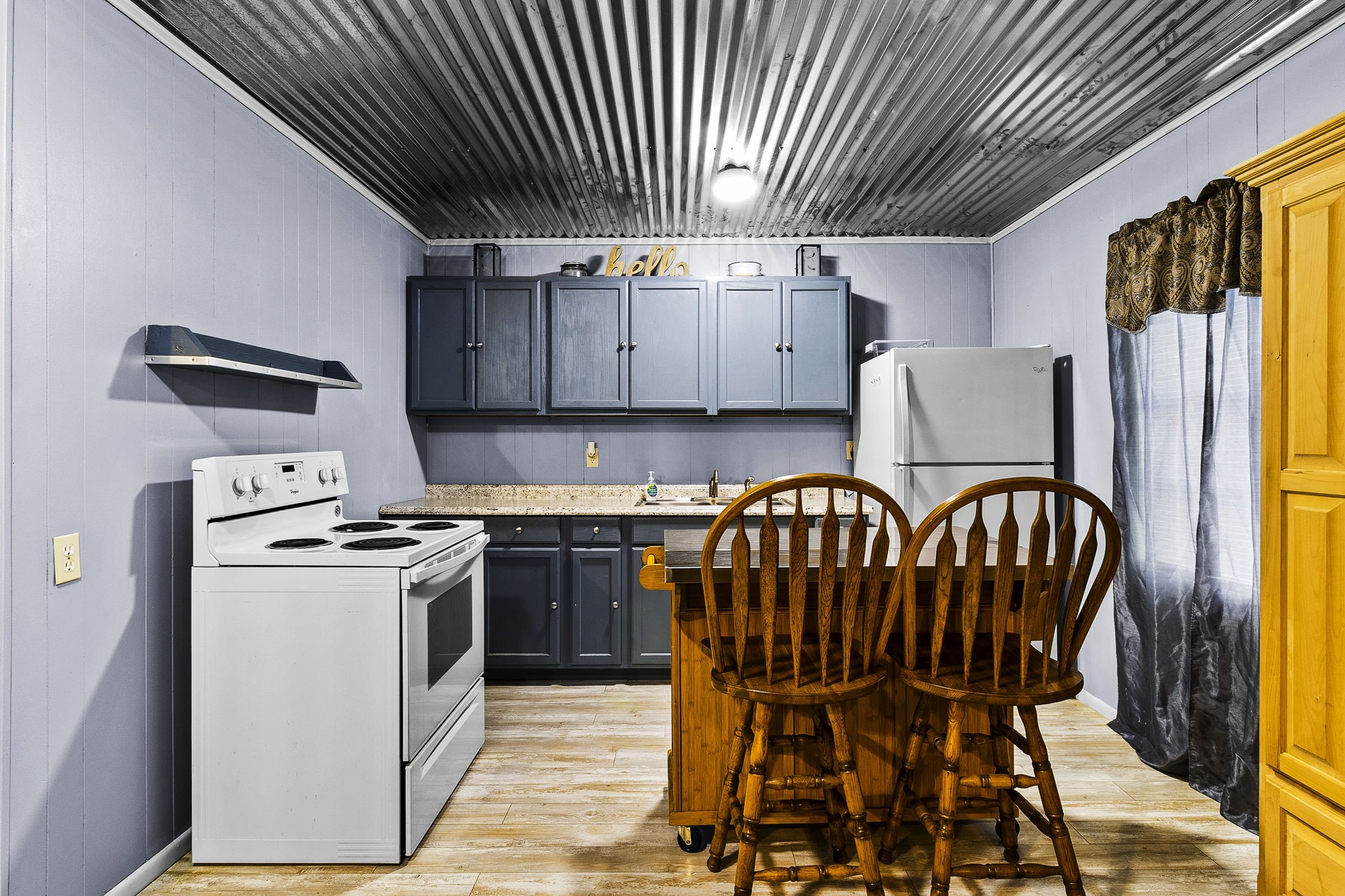 126 Pine Ridge Onalaska, TX 77360 - Photo 10 of 16 a kitchen with stainless steel appliances granite countertop a stove a refrigerator a dining table and chairs with wooden floor