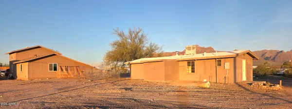 a living room with furniture a table and a painting on the wall
