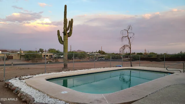 a view of a swimming pool with a terrace and a chair