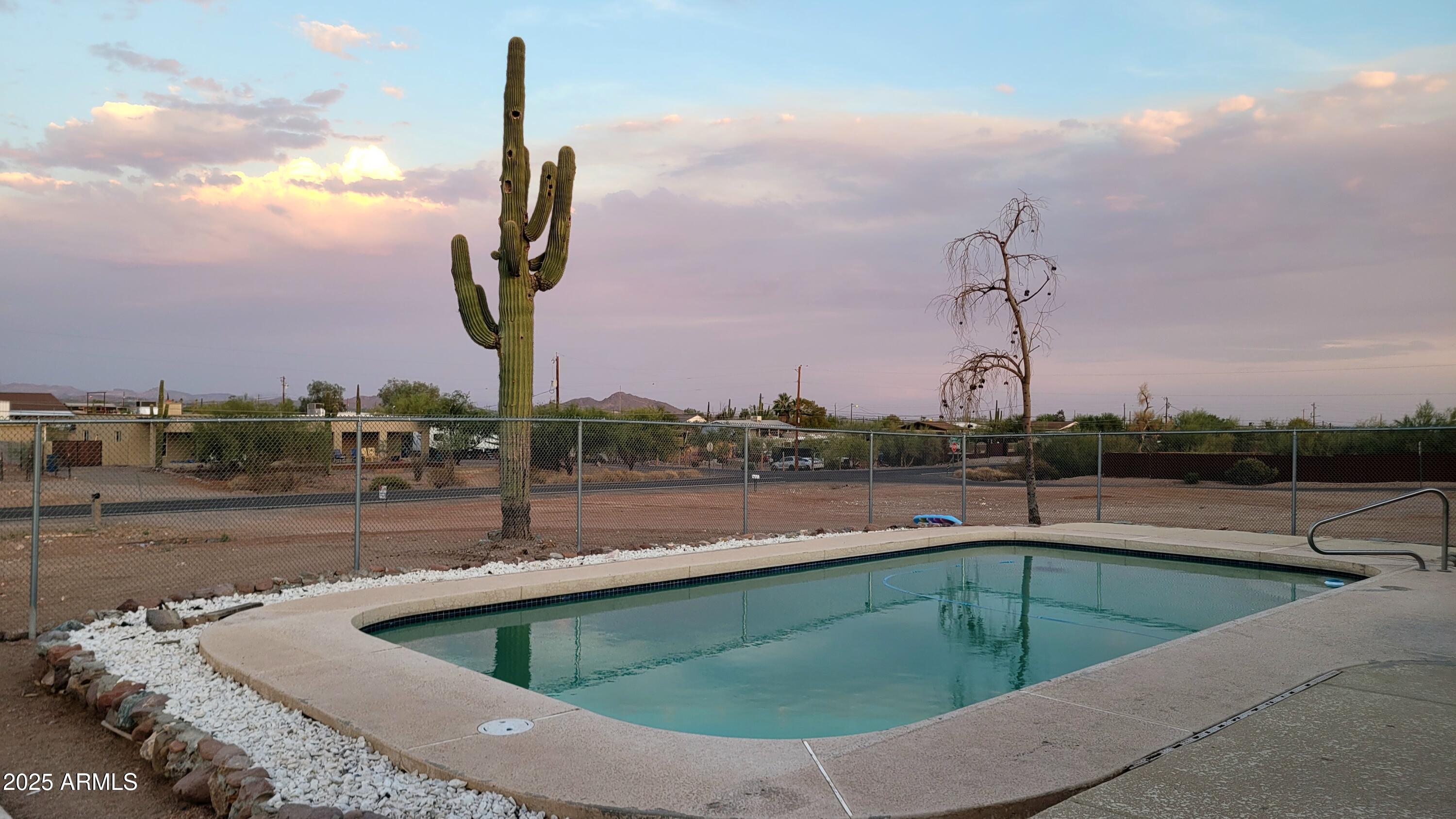 522 South Cortez Road Apache Junction, AZ 85119 - Photo 25 of 48 a view of a swimming pool with a terrace and a chair