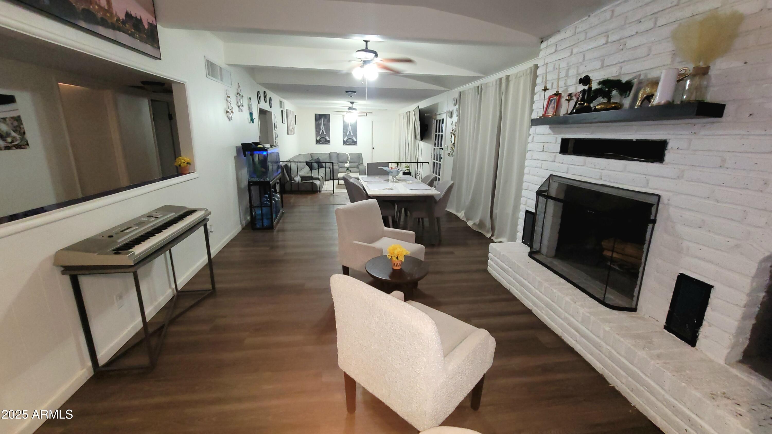 522 South Cortez Road Apache Junction, AZ 85119 - Photo 32 of 48 a living room with furniture and a fireplace