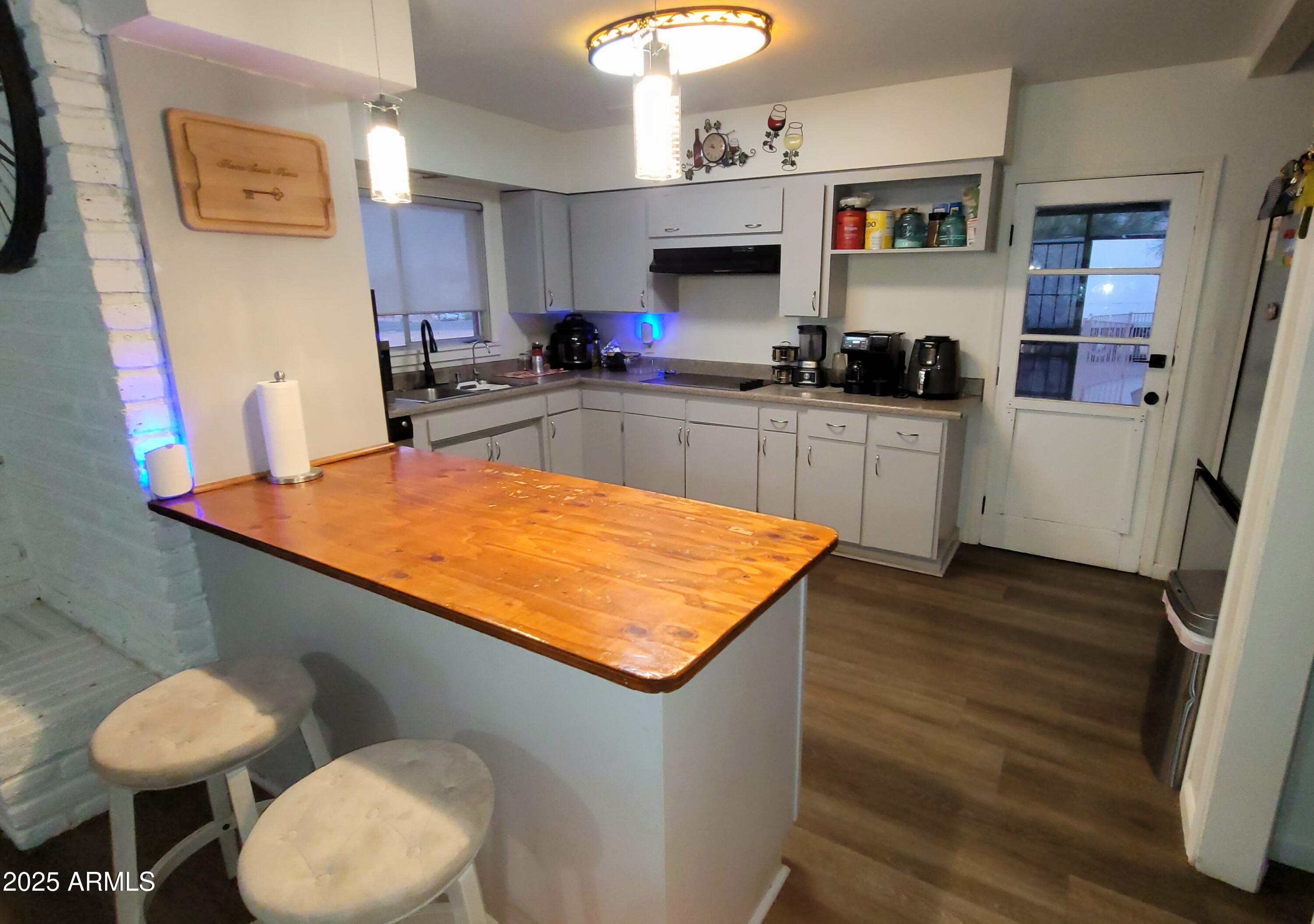 522 South Cortez Road Apache Junction, AZ 85119 - Photo 35 of 48 a kitchen with stainless steel appliances granite countertop a sink and a stove