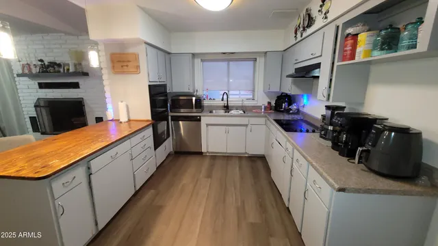 a kitchen with sink a stove and cabinets