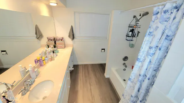 a bathroom with a tub sink and mirror