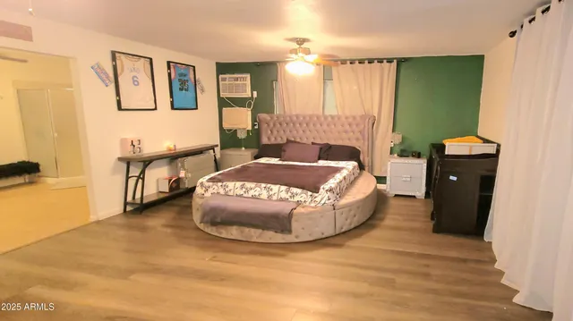 a spacious bedroom with a bed and a table in it