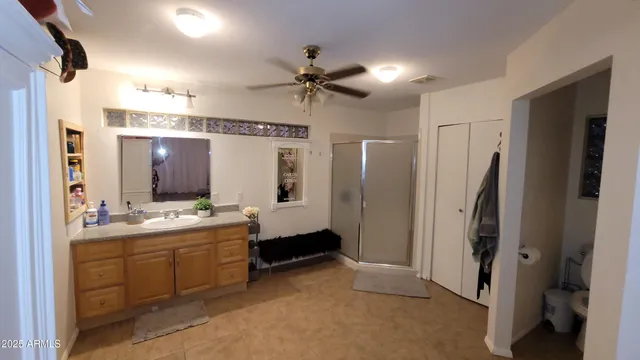 a bathroom with a double vanity sink mirror and shower