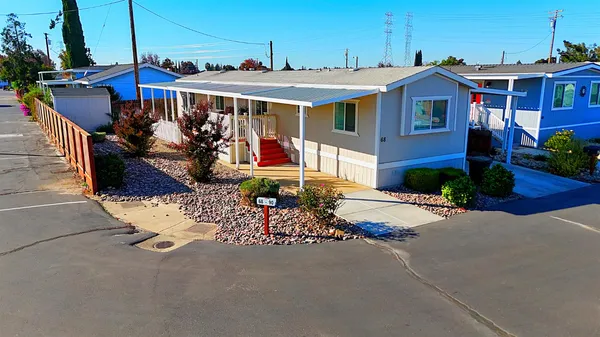 a view of a house with a yard and sitting area