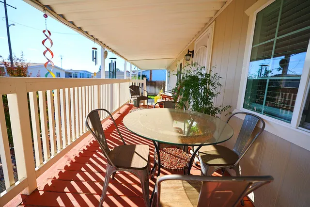 a view of balcony with a table and chairs