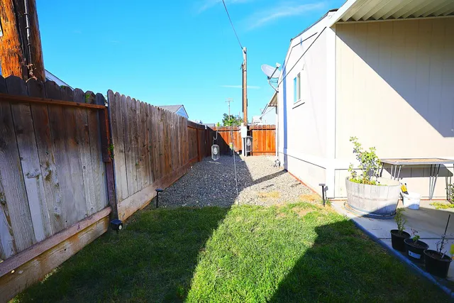 a view of a backyard with sitting area