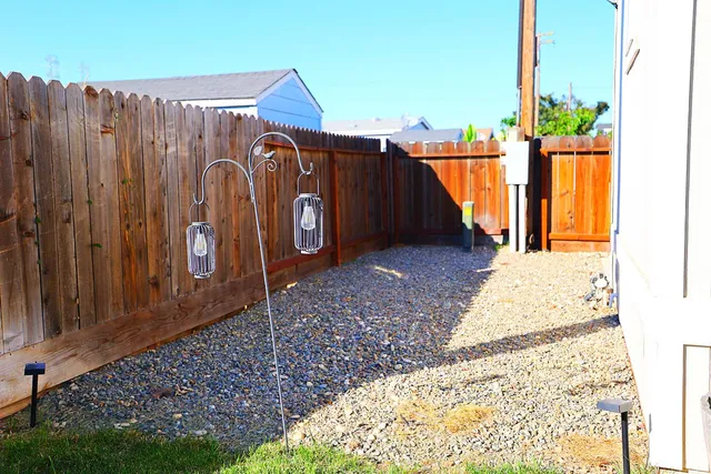 a view of a backyard with a wooden fence