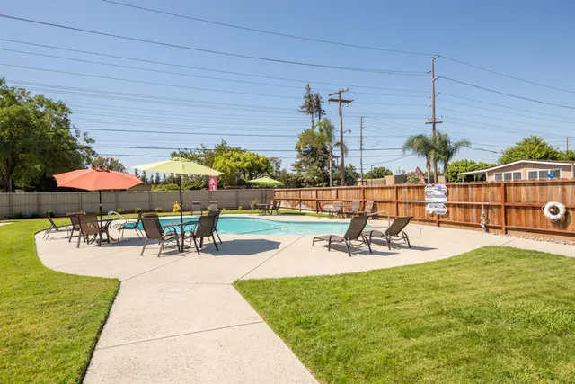 a view of swimming pool with outdoor seating and city view