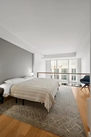 a bed sitting in a bedroom next to a window