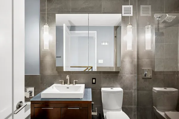 a bathroom with a sink toilet and mirror