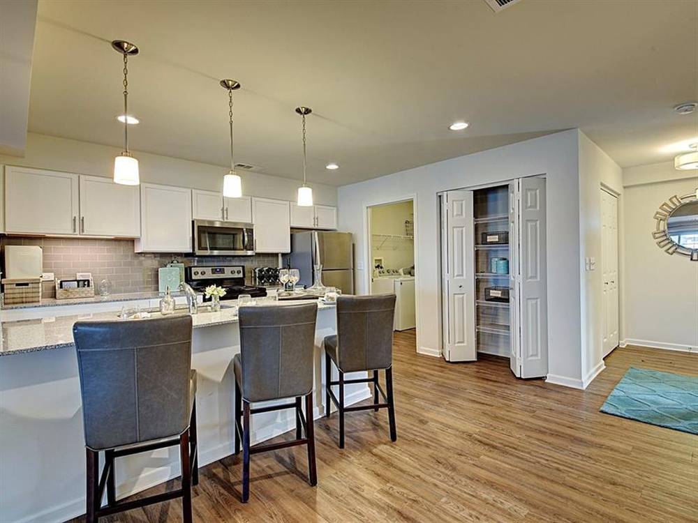 4215 Pond Willow Road Naperville, IL 60564 - Photo 4 of 13 a kitchen with stainless steel appliances a dining table chairs stove and refrigerator